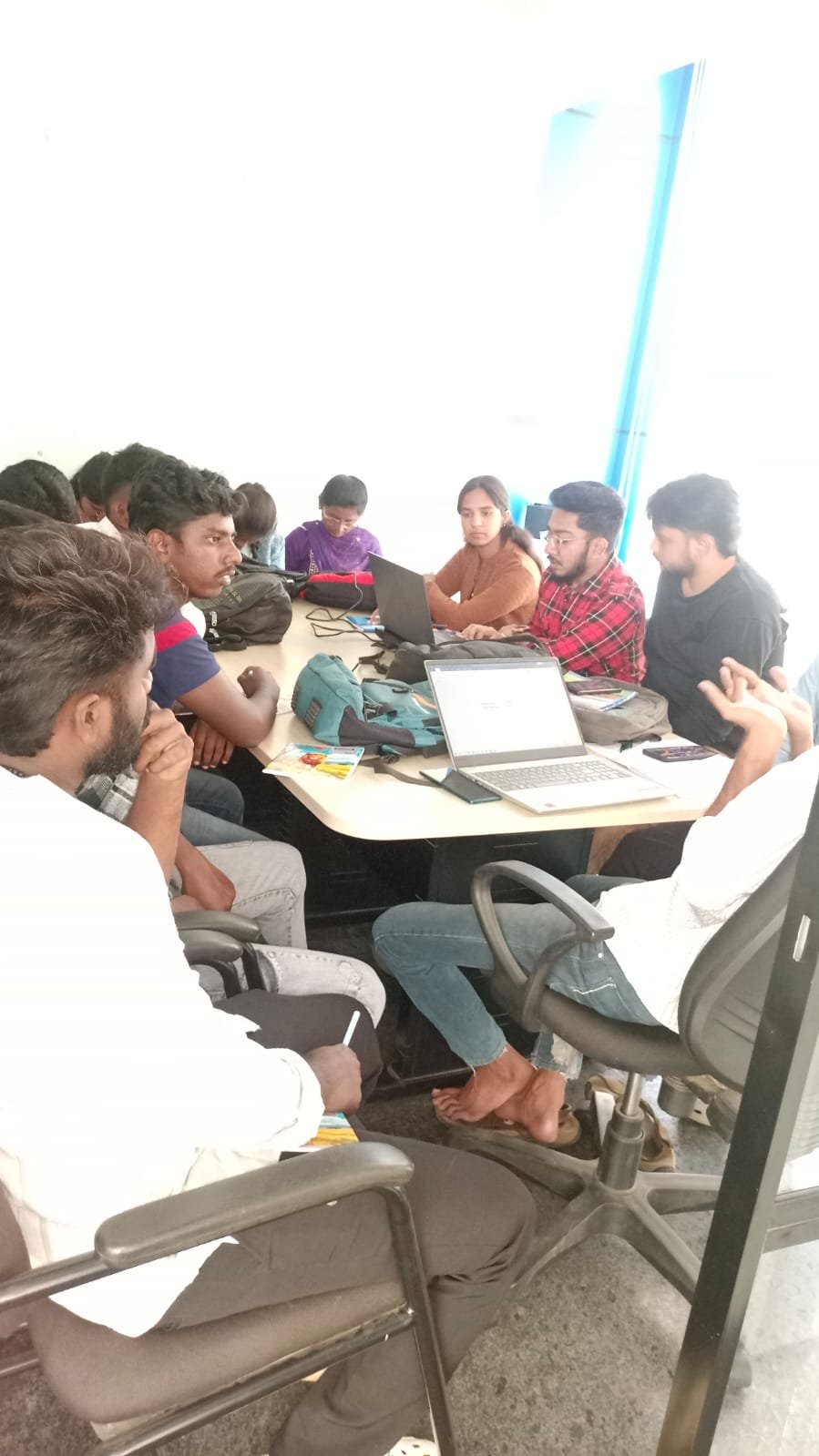 Founder mentoring students around laptop